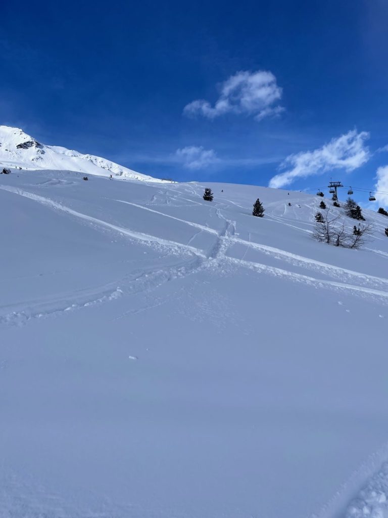 Frisch präparierte, leere Piste mit ersten Spuren im Schnee